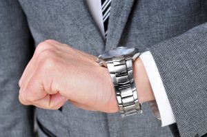 Businessman checking the time on his watch