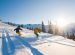 Couple skiing on a sunny powder day