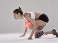 Studio shot of an athlete with an injury highlighted in glowing red